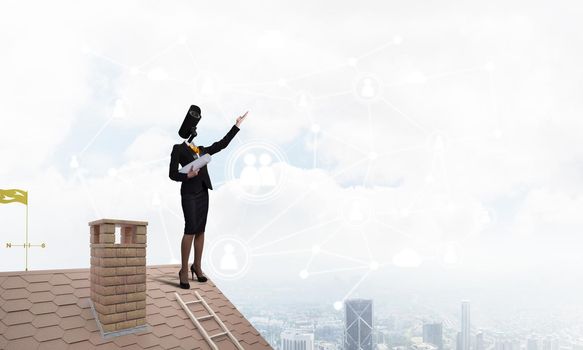 Faceless businesswoman with camera zoom instead of head standing on house roof