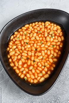 Baked beans in tomato sauce in a plate. White background. top view.