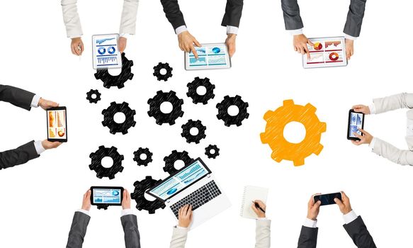 Group of people with devices in hands working together as symbol of networking and communication