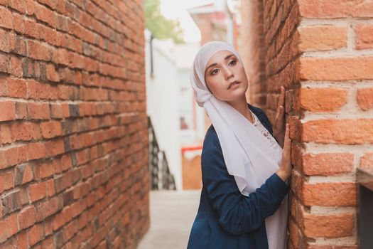 Portrait of a Muslim woman posing outdoors. Modern islamic female concept.