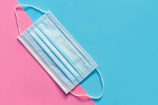 Ear loop face mask layers, protective masks on a blue and pink background. dust protection respirator and respiratory medical respiratory mask