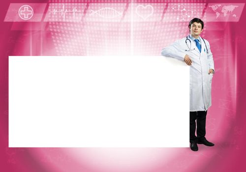 Young handsome doctor with white blank banner. Place your text