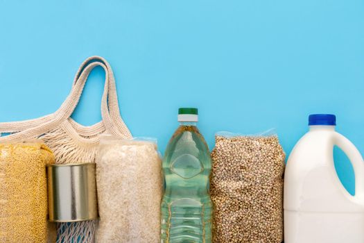 Food delivery. Raw porridge, cereals, milk and vegetable oil on a white table. Copy of the space, flat. Food security for the poor.