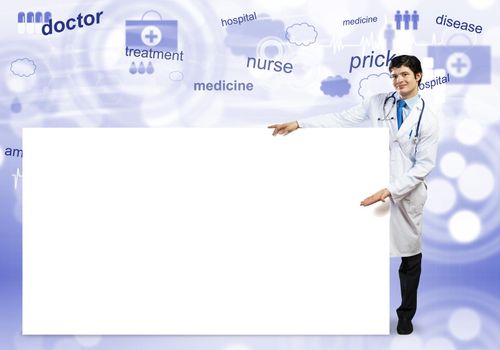 Young handsome doctor with white blank banner. Place your text