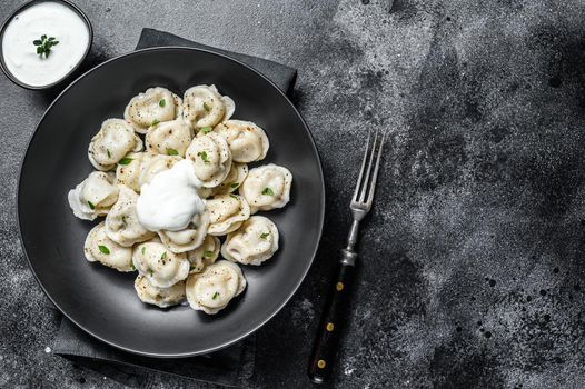 Homemade ravioli dumplings with beef and pork meat. Black background. top view. Copy space.