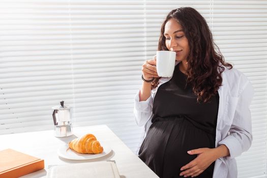 Pregnant woman eating breakfast. Pregnancy and maternity leave.