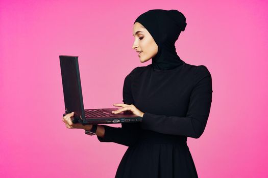 cheerful muslim woman with laptop education student internet technology. High quality photo