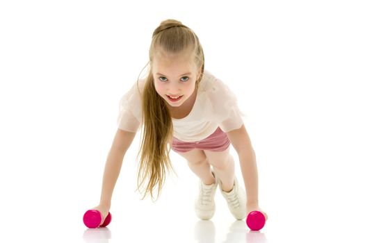 A cute little girl doing exercises with dumbbells. The concept of strength, health and sport. Isolated on white background.