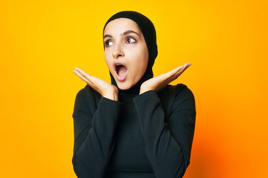 pretty woman in black hijab posing fashion hand gesture isolated background. High quality photo