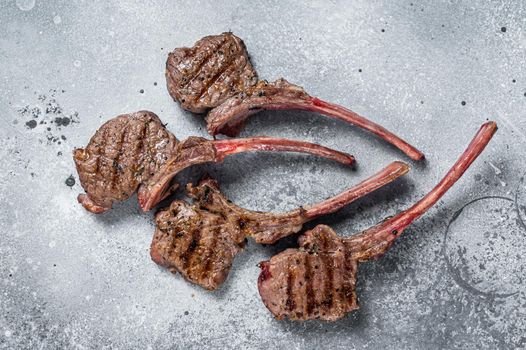 Grilled lamb mutton meat chops steaks. Gray background. Top view.