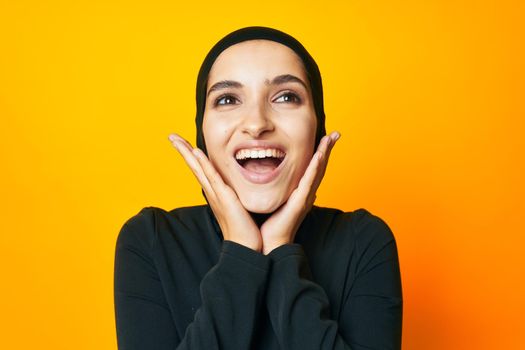 Muslim happiness fashion clothing hand gesture yellow background. High quality photo