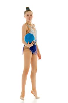 Beautiful little girl gymnast performs exercises with the ball. The concept of children's sports, fitness. Isolated on white background.