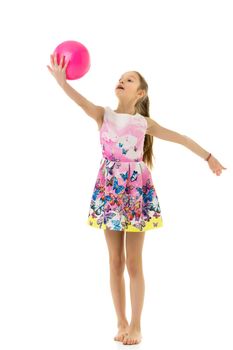 Beautiful little girl gymnast performs exercises with the ball. The concept of children's sports, fitness. Isolated on white background.