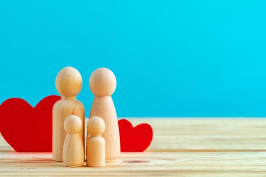 Wooden little figures of people close up. Family concept