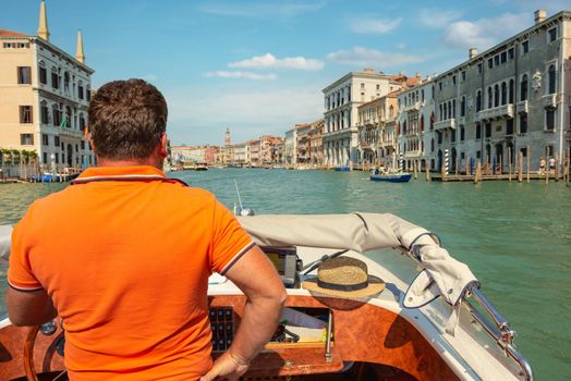 Boats in narrow venetian water canal, Italy