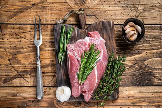 Fresh Raw pork shoulder meat with ingredients and spices on wooden butcher board. wooden background. Top view.