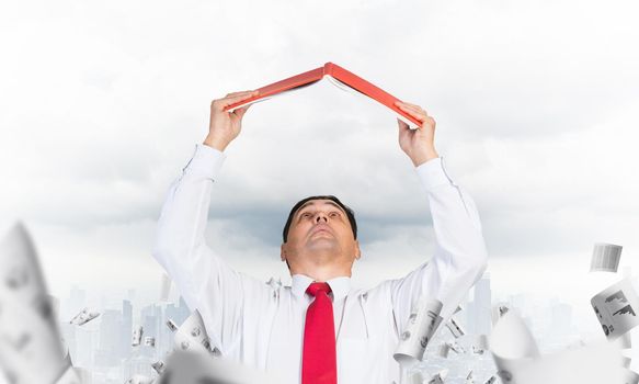Senior businessman holding open diary overhead. Man in shirt and tie standing on cityscape background with falling paper documents. Paperwork and bureaucracy concept. Time management and planning.