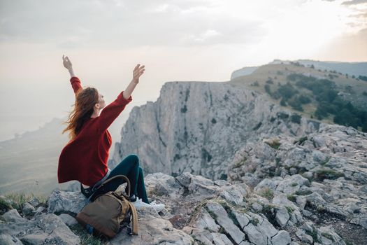 woman with backpack in mountains at altitude landscape nature. High quality photo