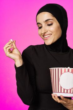 arab woman fun popcorn entertainment fashion isolated background. High quality photo
