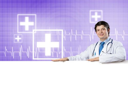 Young handsome doctor holding white blank banner. Place your text