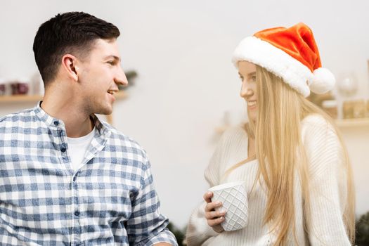 Young festive couple spending time togather in room, close up