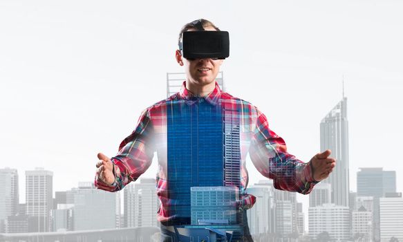 Young man with virtual reality headset or 3d glasses over cityscape background