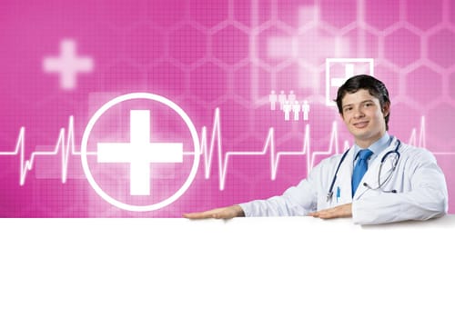 Young handsome doctor holding white blank banner. Place your text