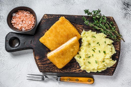 French traditional cuisine chicken fried cordon bleu meat cutlet. White background. Top view.