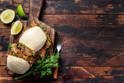 Chinese sandwich steamed gua bao buns with pork. Black background. Top view. Copy space.