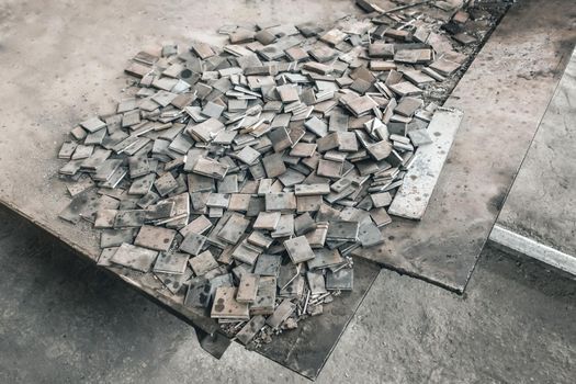 Metal waste, embedded parts for concrete structures with reinforcement, iron plates, industrial waste at the construction site.