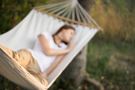 woman sleeping in hammock outdoors leisure lifestyle. High quality photo