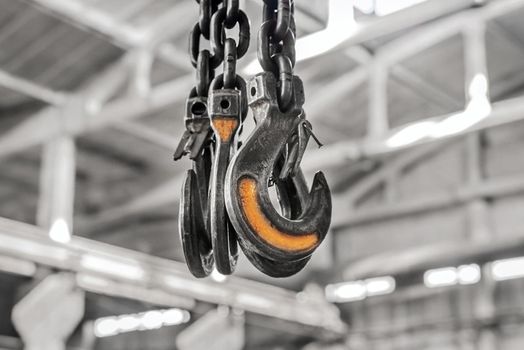 Lifting mechanism iron chain industrial plant equipment with a hoist moving hook.