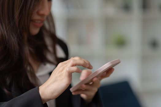 Asian girl using in hands mobile phone close up, online wi-fi internet.