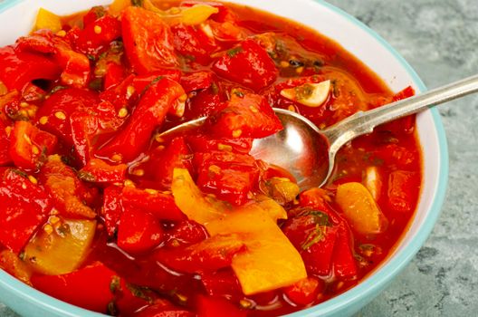 Vegetable dish of stewed sweet peppers and tomatoes, lecho, vegetarian menu. Studio Photo