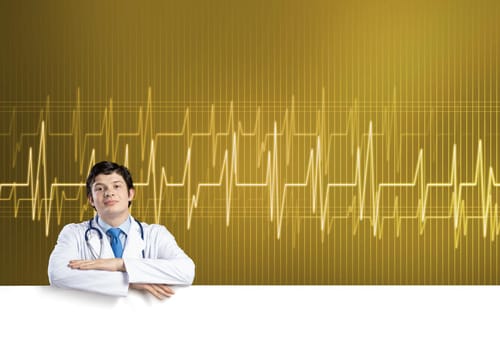 Young handsome doctor holding white blank banner. Place your text