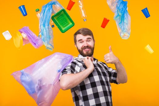 World Environment Day, plastic recycling problem and environmental disaster concept - Funny man holding garbage bag for recycling and showing thumb up. Do like me.