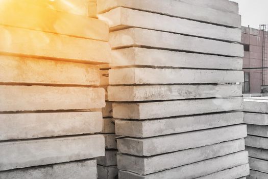 Storage of concrete blocks in a warehouse. Concrete structures at the construction site. Industrial, building cement materials.