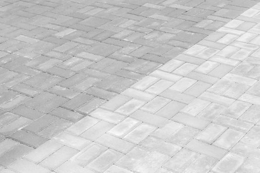 Gray paving slabs urban street road floor stone tile texture background.
