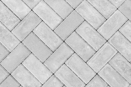 Gray paving slabs urban street road floor stone tile texture background, top view.