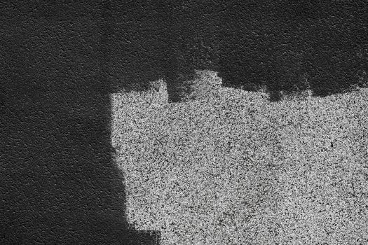 Black dark paint brush strokes on building facade, gray abstract pattern wall surface texture exterior background.