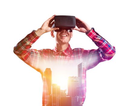 Young man with virtual reality headset or 3d glasses over cityscape background