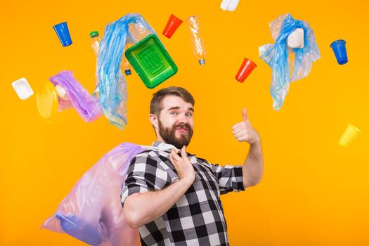 World Environment Day, plastic recycling problem and environmental disaster concept - Funny man holding garbage bag for recycling and showing thumb up. Do like me.