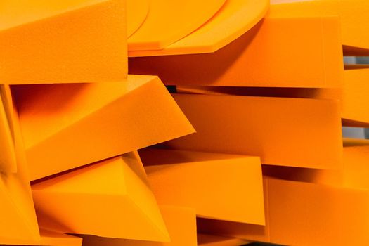 A pile of color orange polystyrene industrial foam material storage on warehouse.