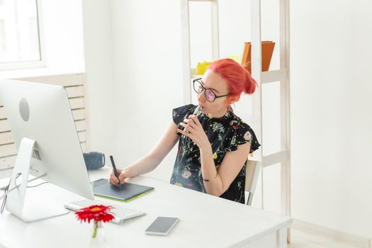 Creative, graphic designer, people concept - young creative woman smoking a vape while working in a graphic tablet.