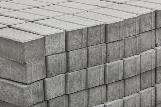 A pile of packed paving stone slabs industrial tile sidewalk materials at a construction site.