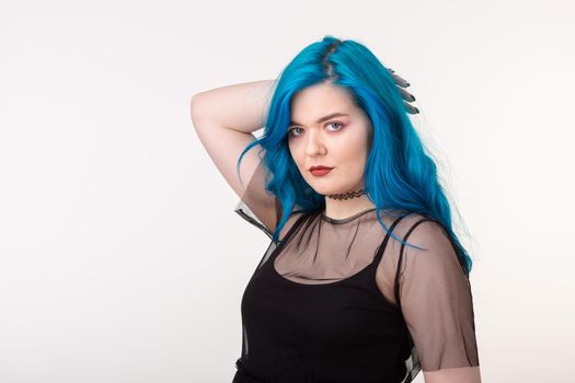 People and fashion concept - Beautiful woman with blue hair posing over white background.