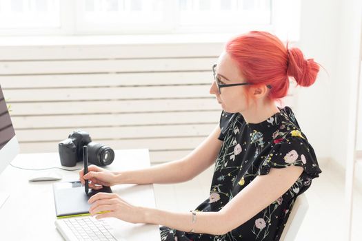 Creative, illustrator, graphic and people concept - Creative businessman writing or drawing on graphic tablet while using laptop in office