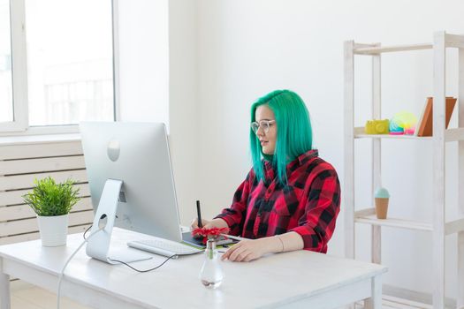 Creative, illustrator and designer concept - happy woman with green hair is drawing a project.