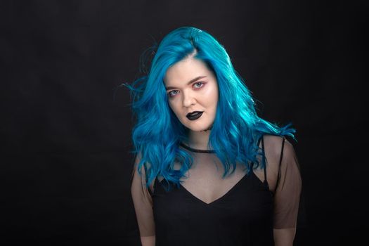 People, style and fashion concept - Close up portrait of young woman with blue long hair dressed in black dress.