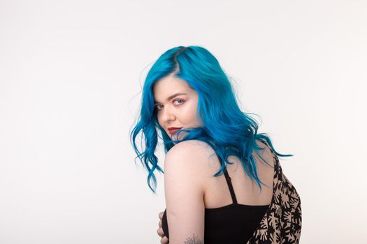 people, fashion and hair concept - beautiful girl with blue hair standing on white background.